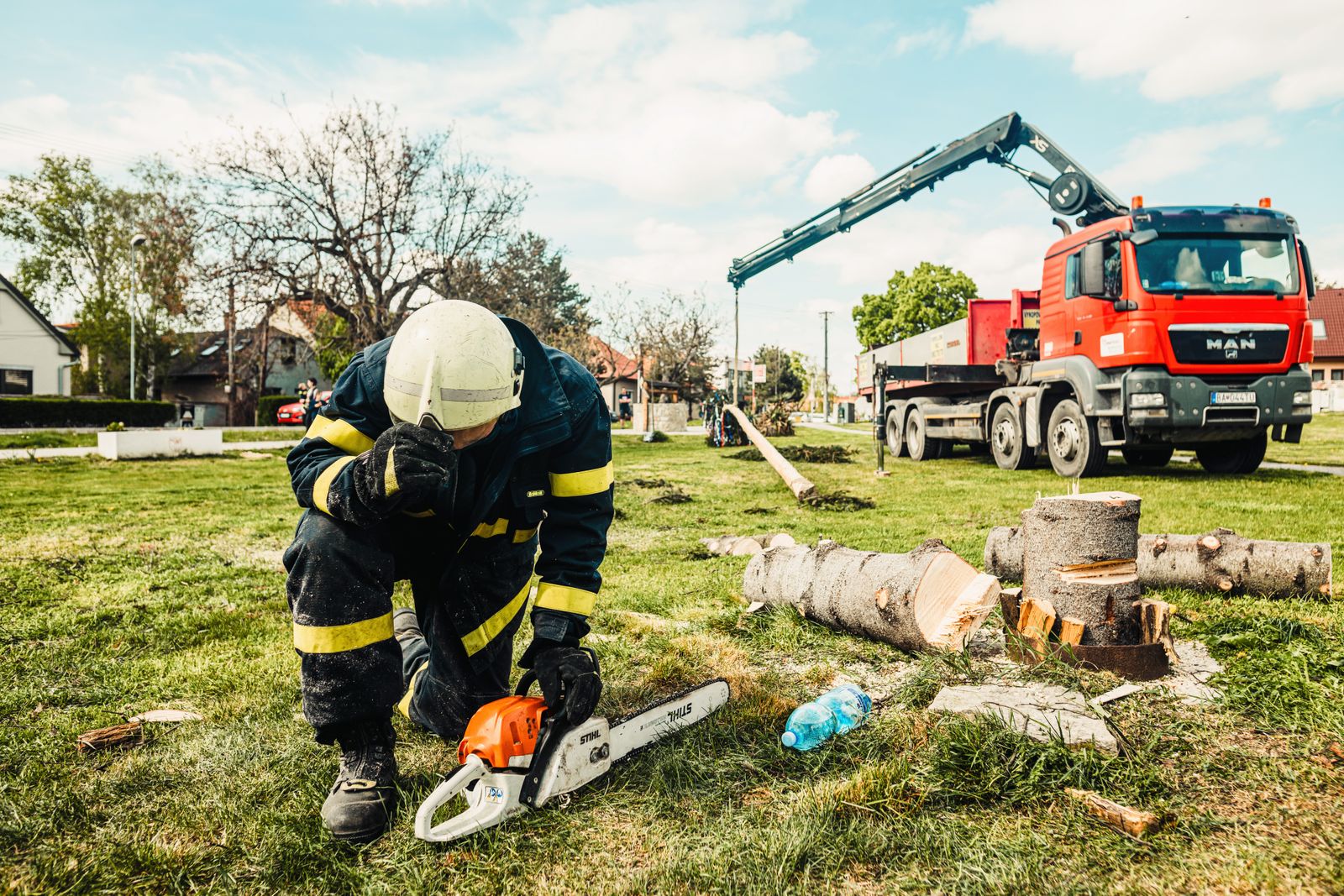 Tree removal crew and professional equipment at a residential property